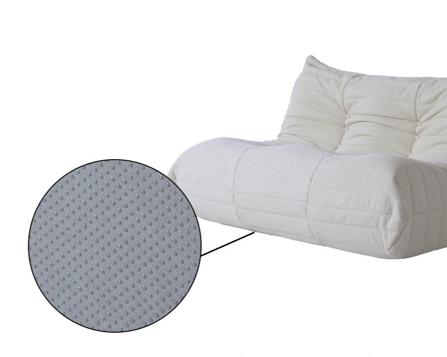 Close-up of an anti-slip bottom of a white togo-style sofa