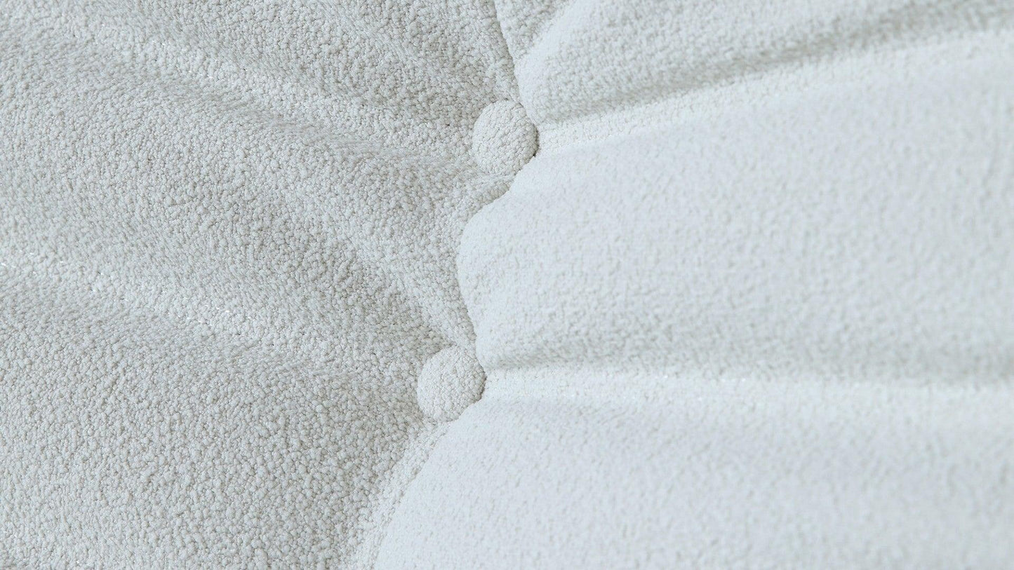 Close-up of buttons of a white togo-style sofa