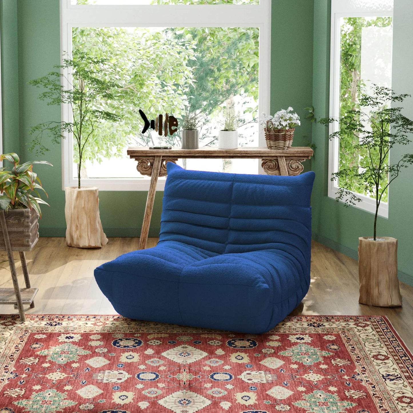 A blue, caterpillar-shaped pet-friendly armchair placed on a patterned rug, featuring a modern ergonomic design.