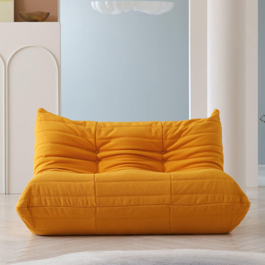 An orange, caterpillar-shaped Togo sofa.