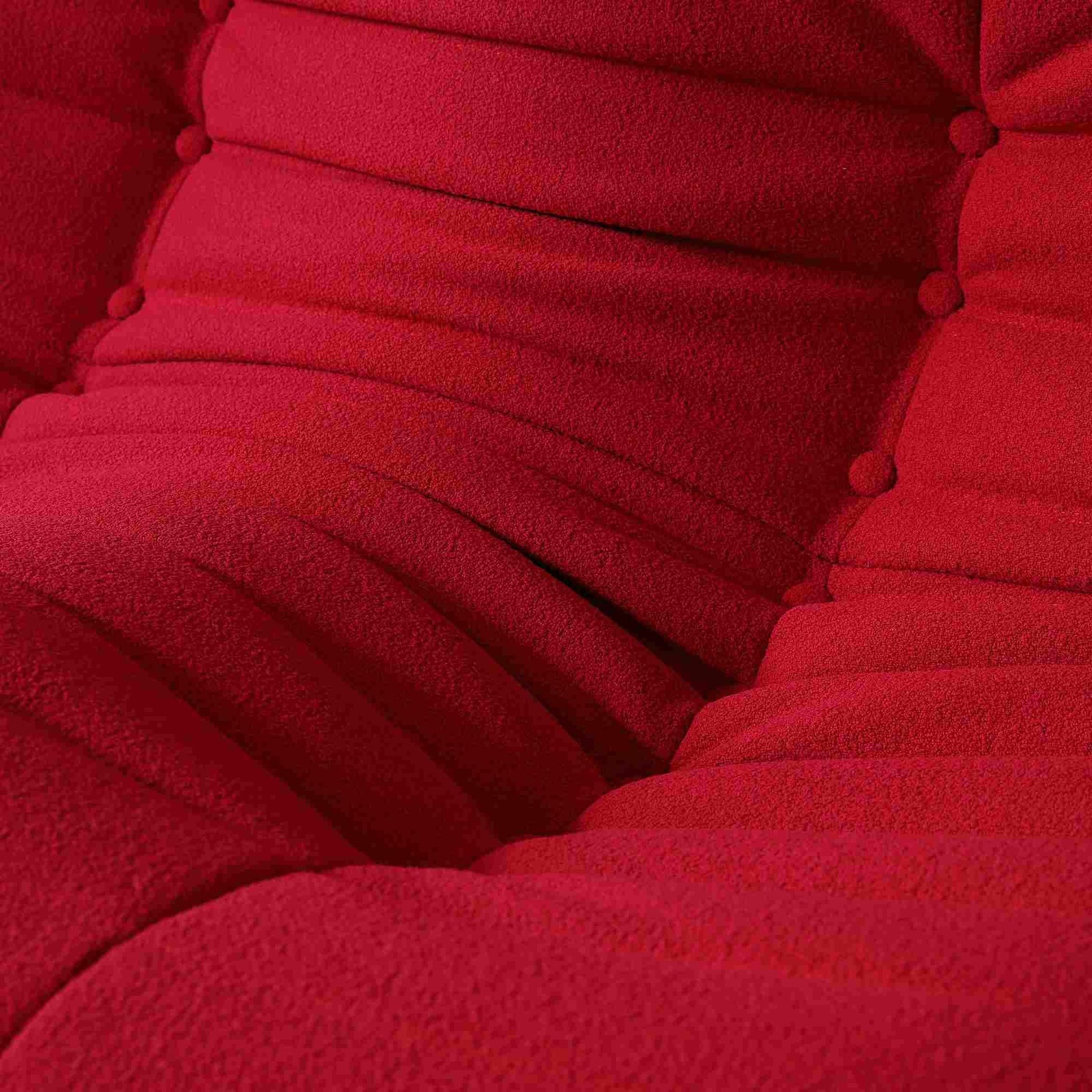 Close-up of a fabric of a caterpillar design of a red togo style sofa