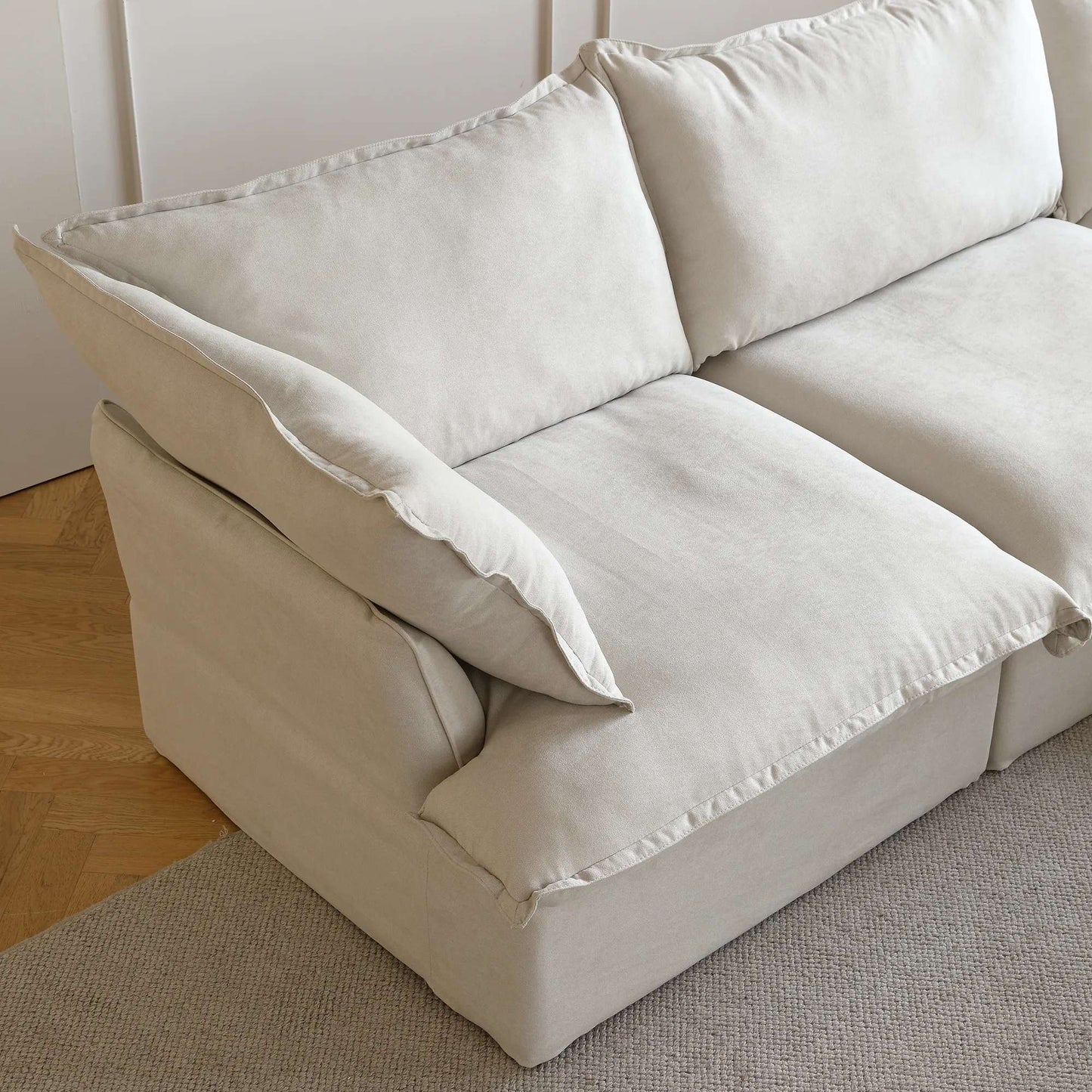 Close-up of a armrest seat of a beige sectional sofa