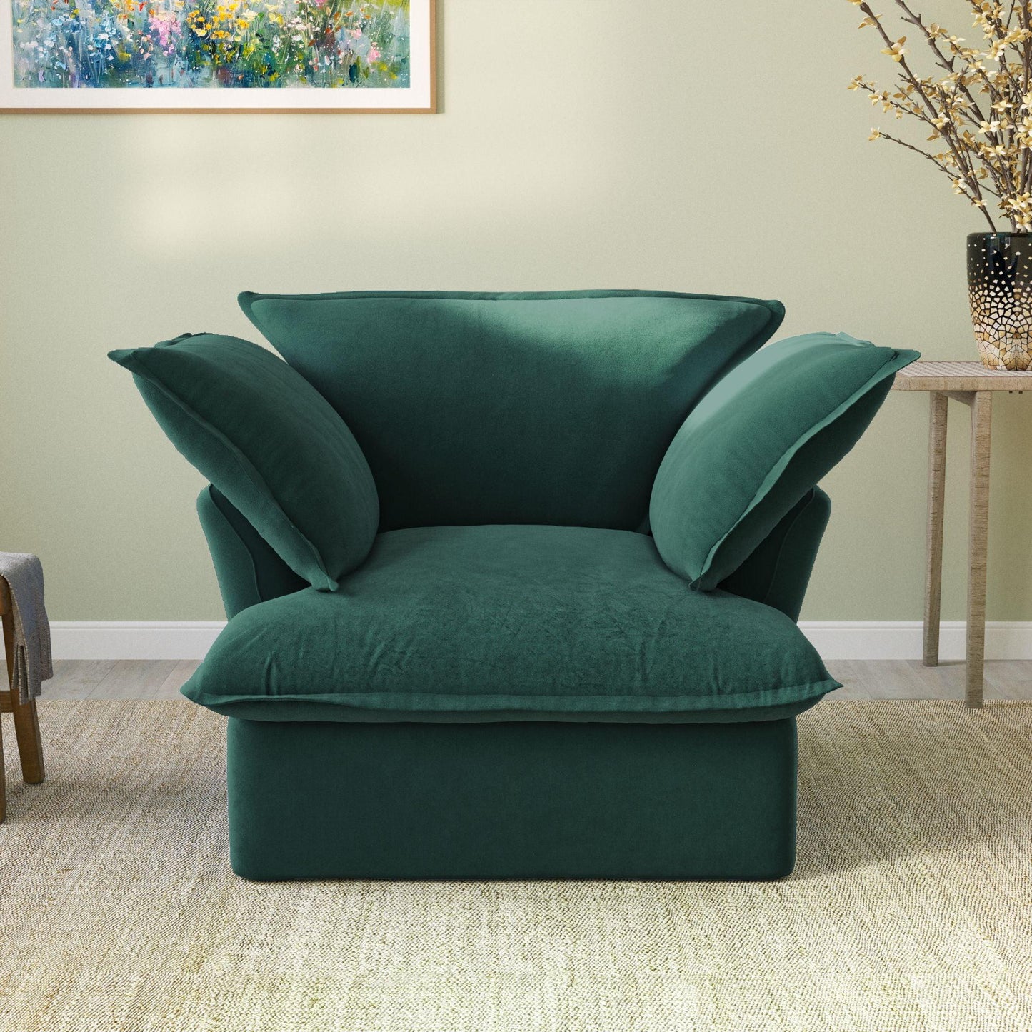 A plush green velvet modular sectional sofa in a cozy living room setting, with a cushioned backrest and seat.