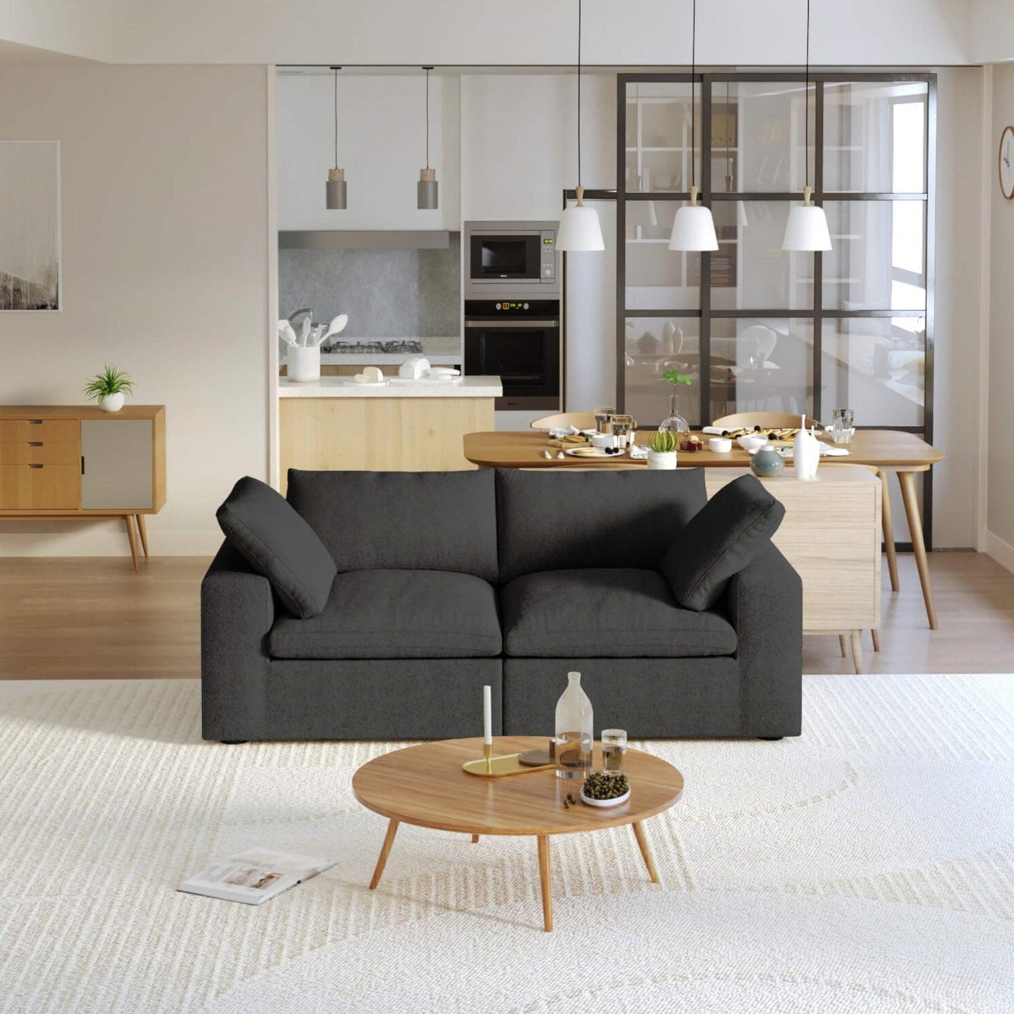 A modern black loveseat sectional sofa in a bright living room setting, featuring a white slipcover, and designed for small space functionality.