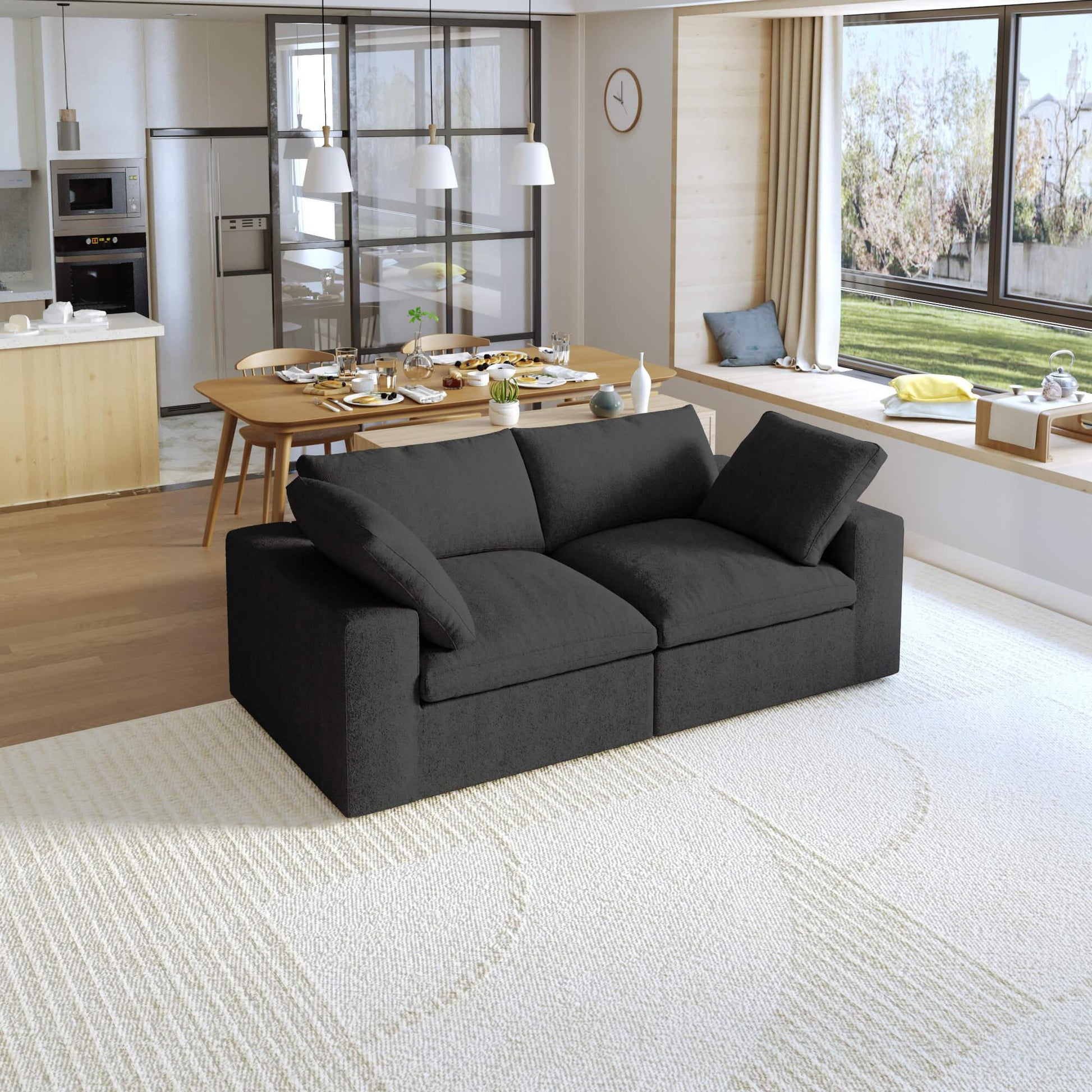 A modern black loveseat sectional sofa in a bright living room setting, featuring a white slipcover, and designed for small space functionality.