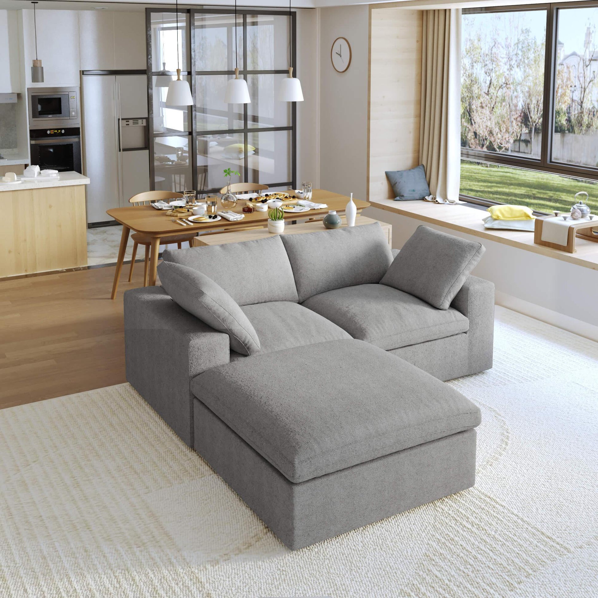A gray modular sectional sofa with a storage ottoman in a modern living room setting.