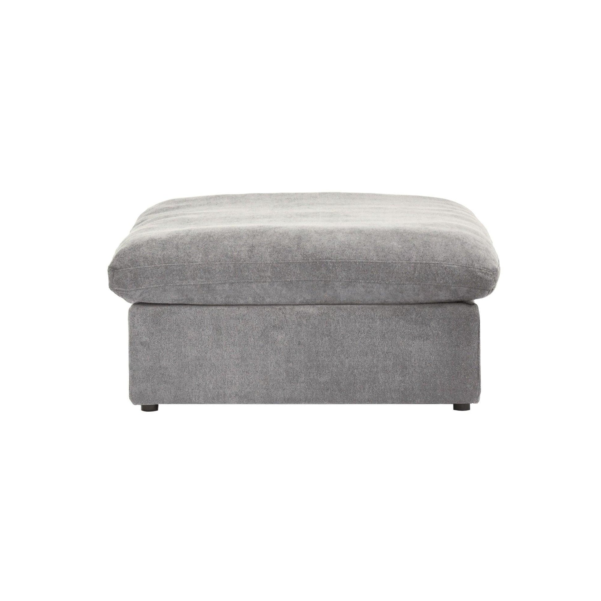 A gray linen upholstered ottoman with a cushioned top.