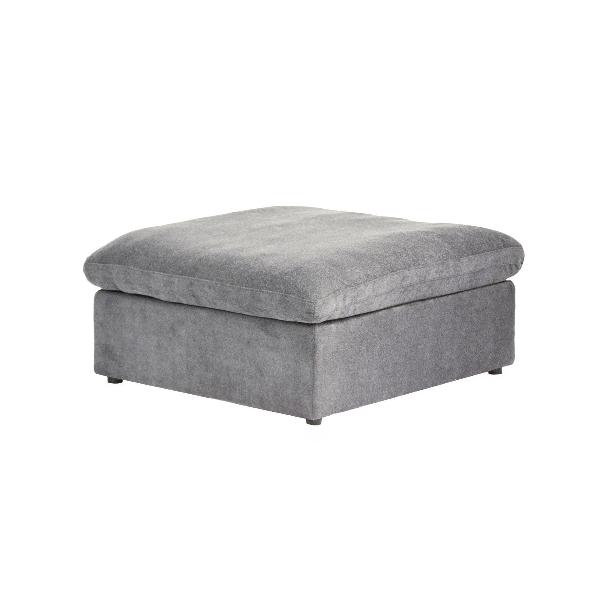 A gray linen upholstered ottoman with a cushioned top.