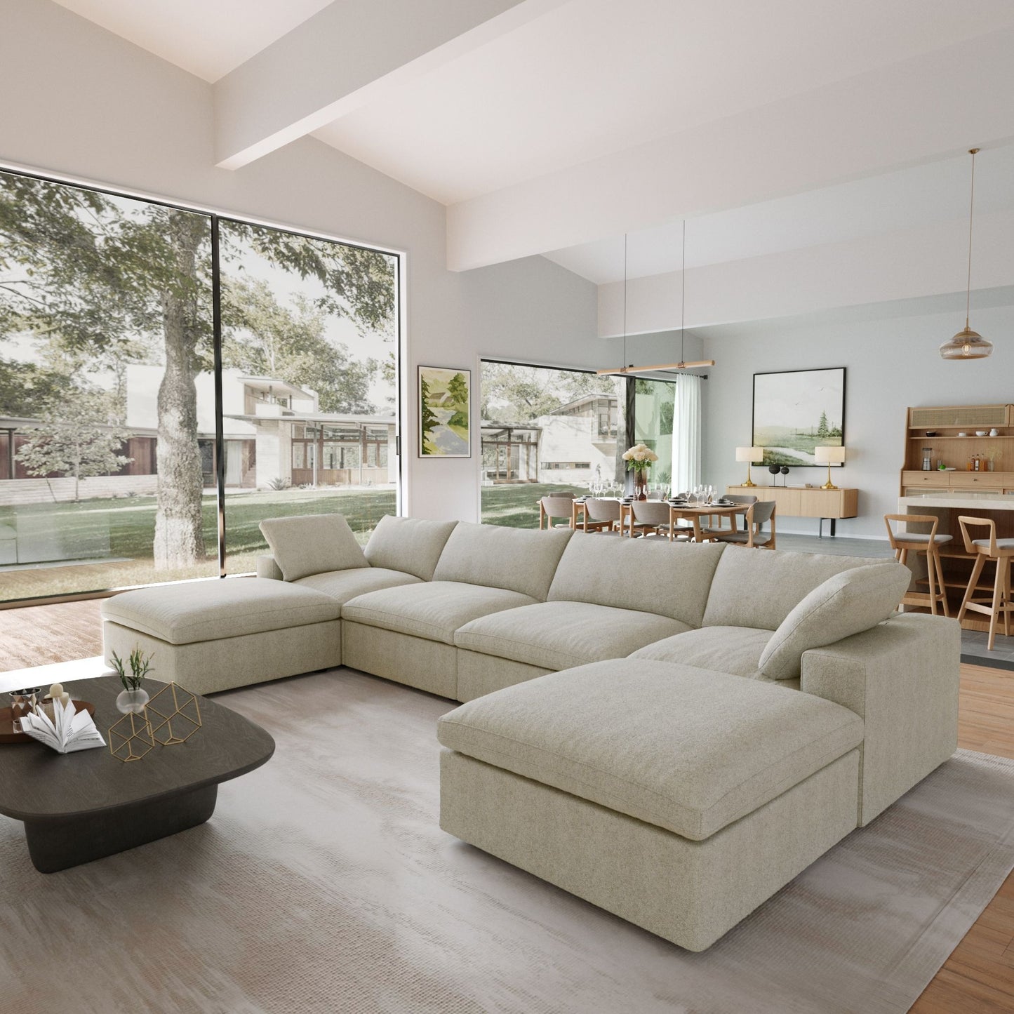 Modern living room with a beige sectional sofa, coffee table, and large windows.