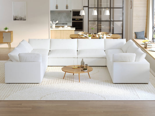 A modern, modular pit-style 8-seat sectional sofa in white in a living room setting with white cushions and a clean, contemporary design.