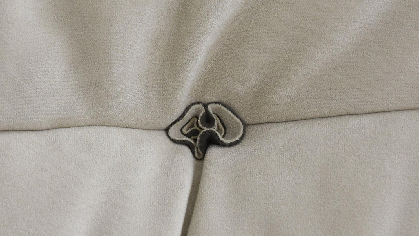 Close-up of a button design of a beige sofa