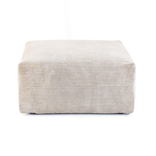 A beige corduroy modular ottoman with removable covers, presented in a minimalist style against a white background.
