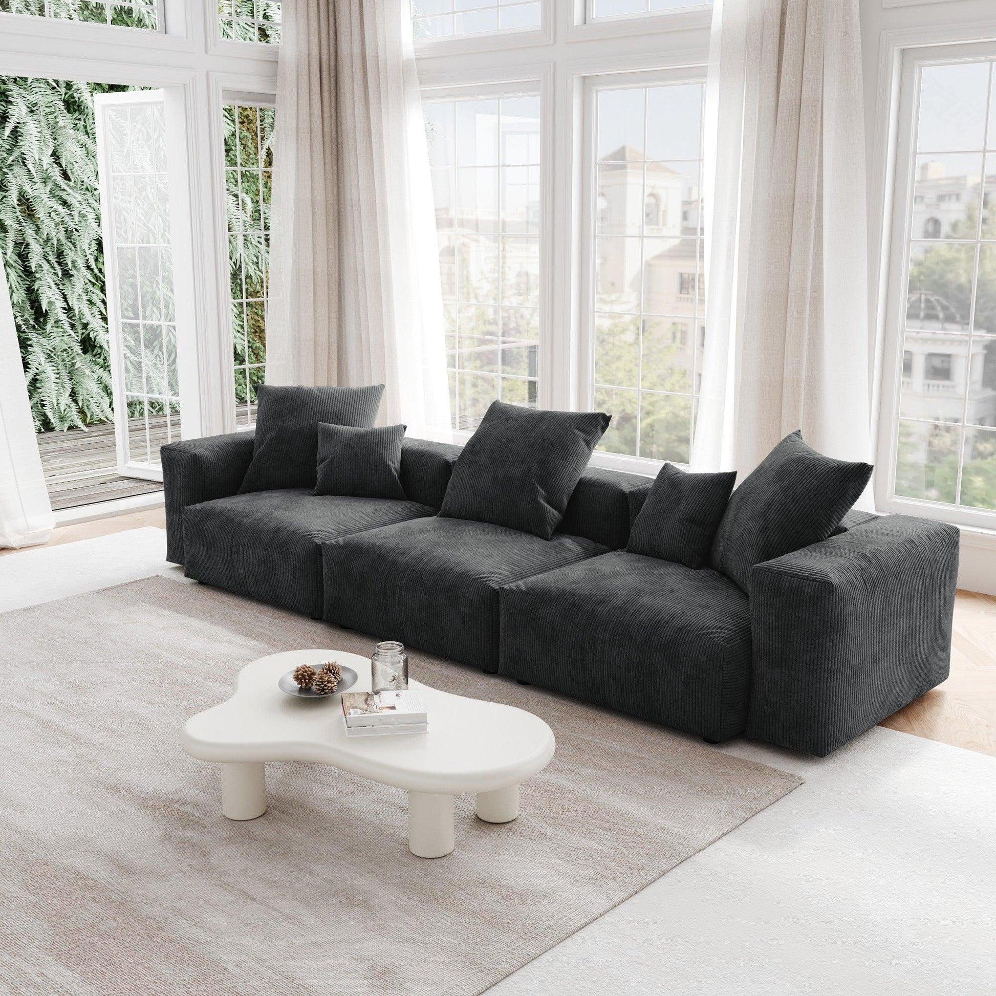 A black corduroy 3-seat sectional modular sofa with detachable armrests and removable covers, pet-friendly, displayed in a bright living space.