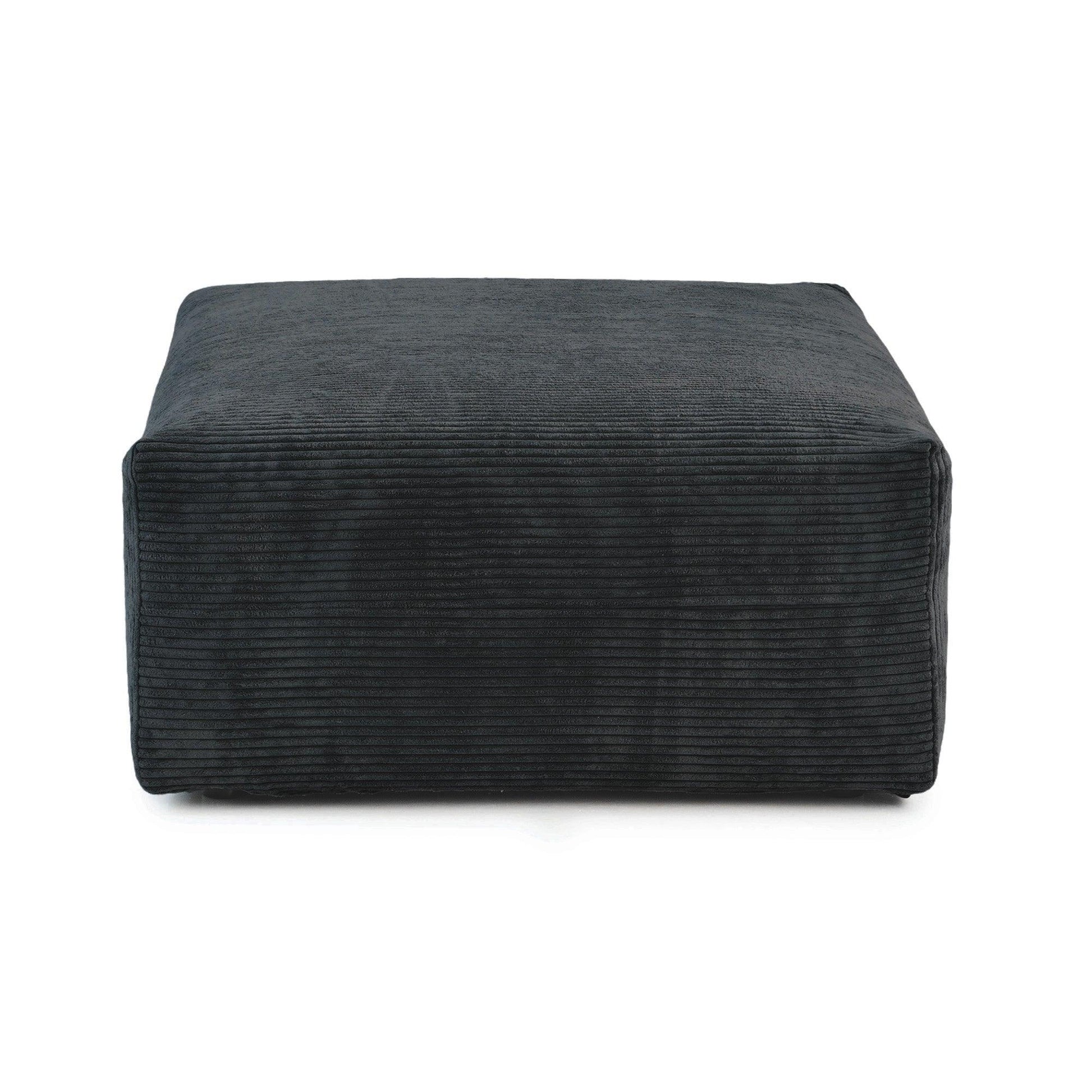 A black corduroy modular ottoman with removable covers, presented in a minimalist style against a white background.