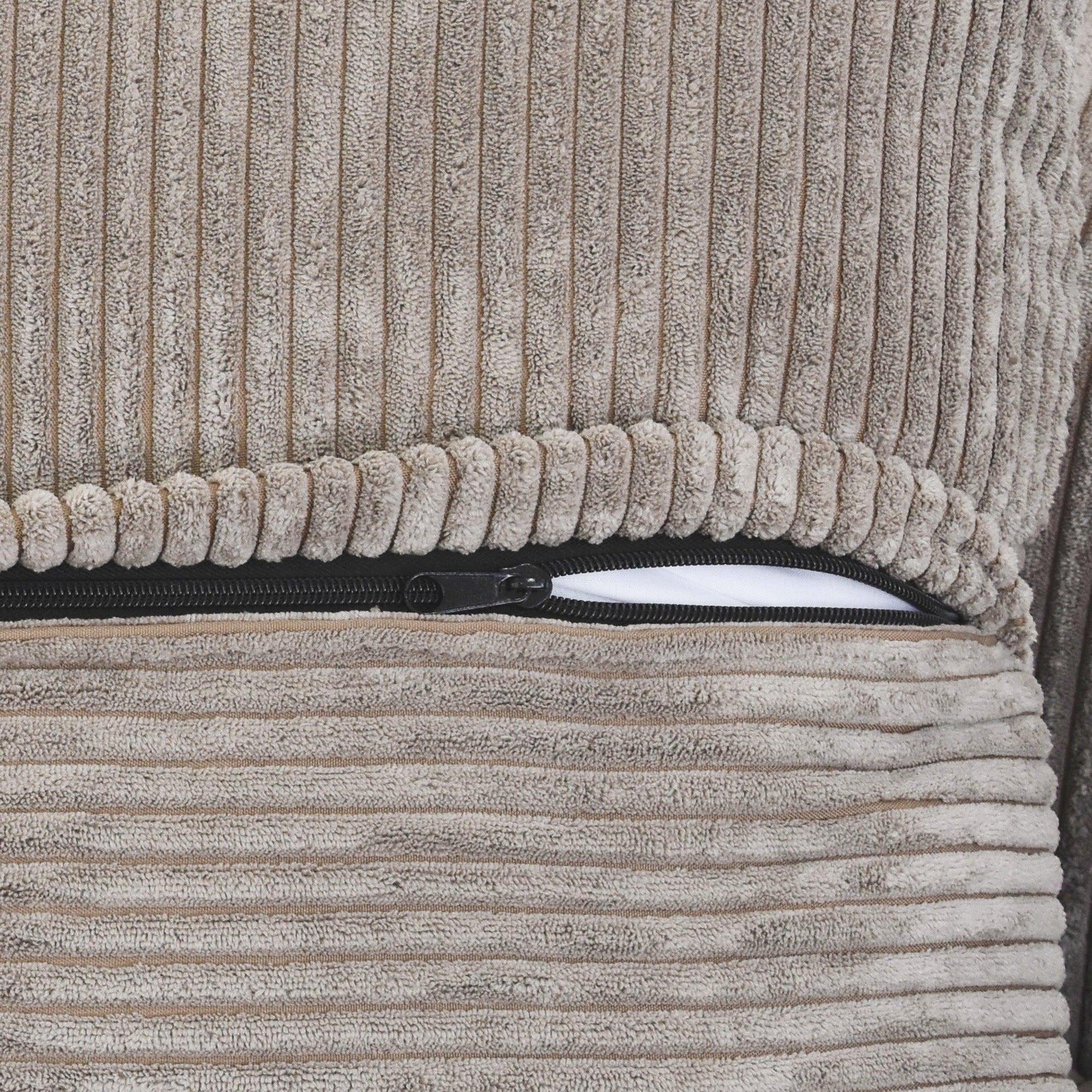 Close-up of a zipper on a brown corduroy sofa cover