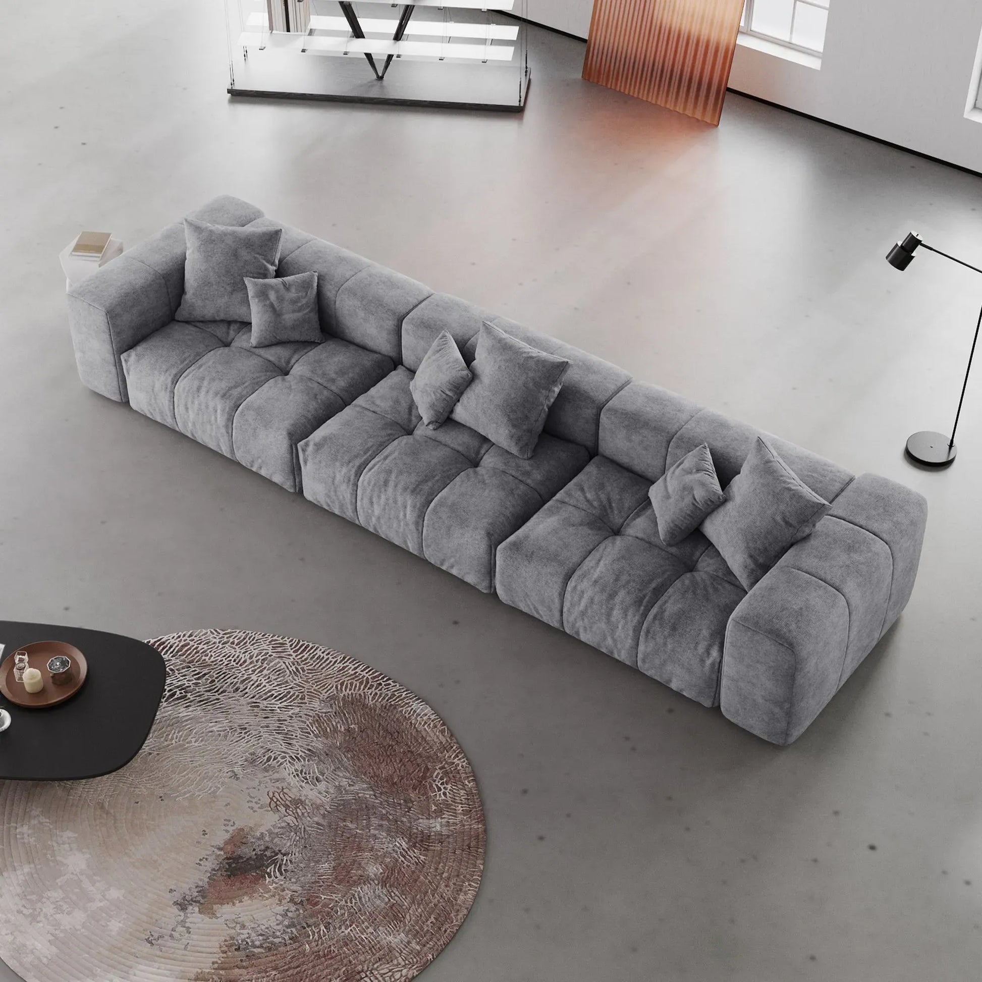 Gray 3-seater sofa with cushions in a modern living room setting