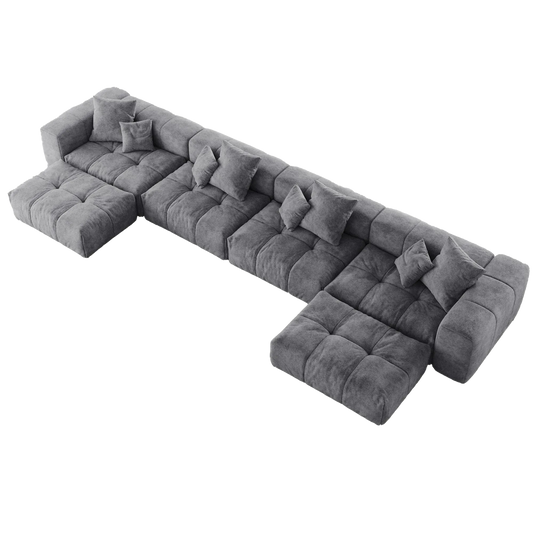 Gray U-shaped sectional sofa with cushions on a white background