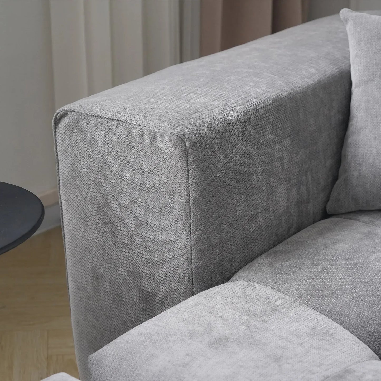 Gray upholstered corner sofa with a neutral background