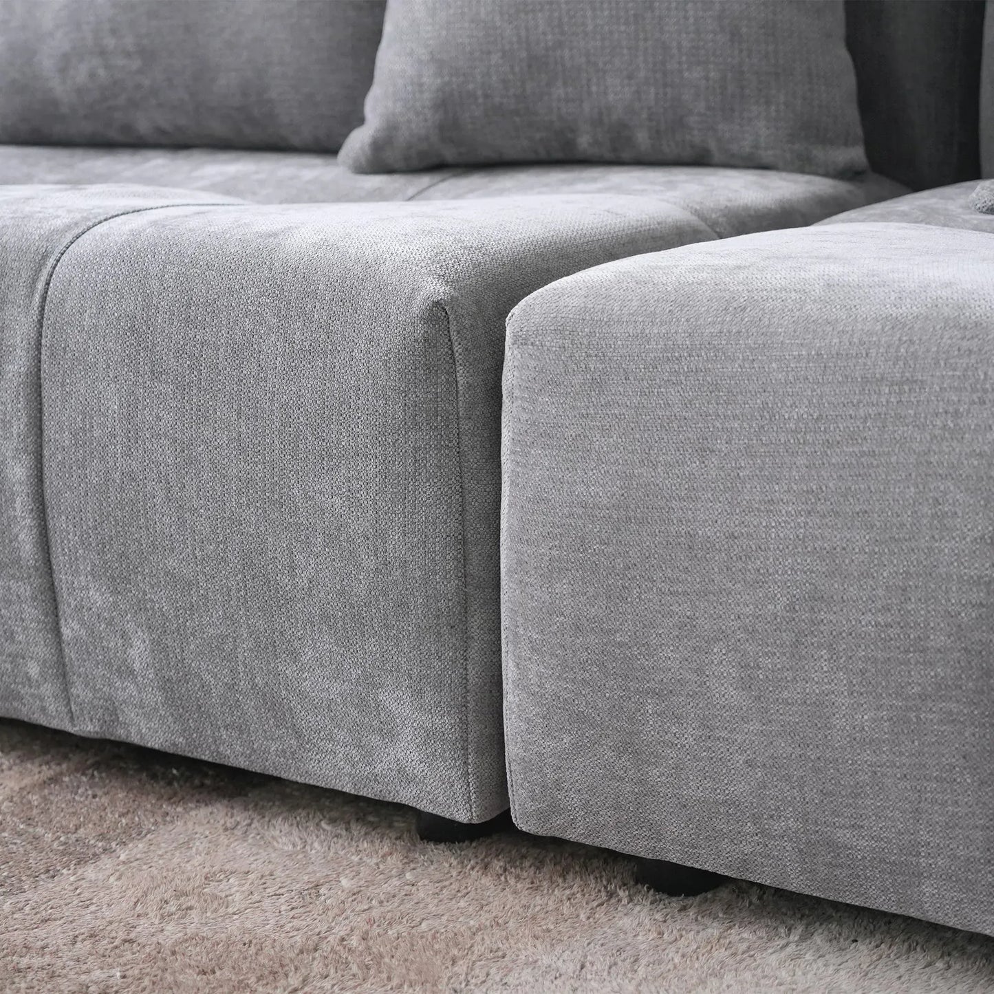 Gray sectional sofa on a carpeted floor