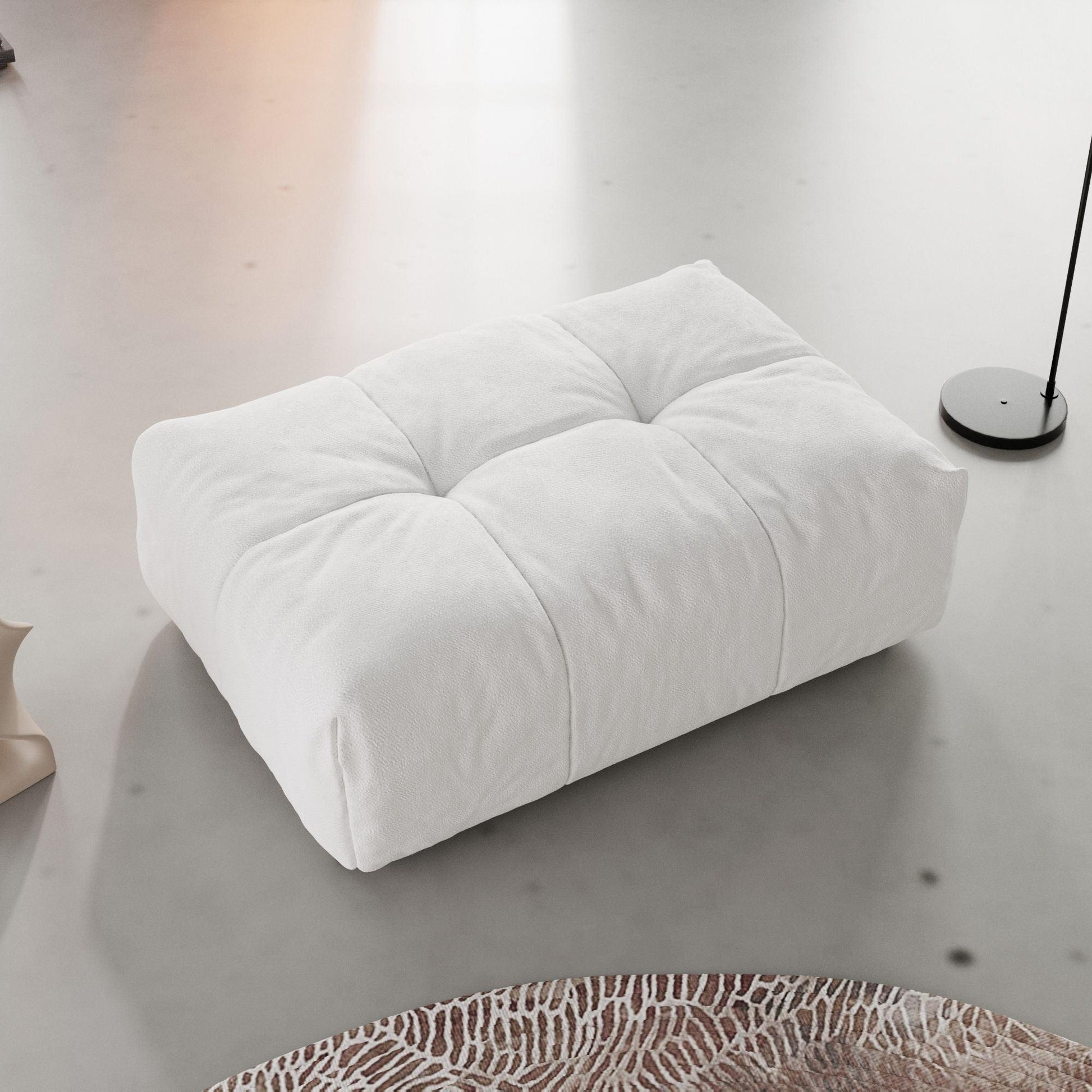 A modern, modular ottoman in white color arranged in a living room setting.