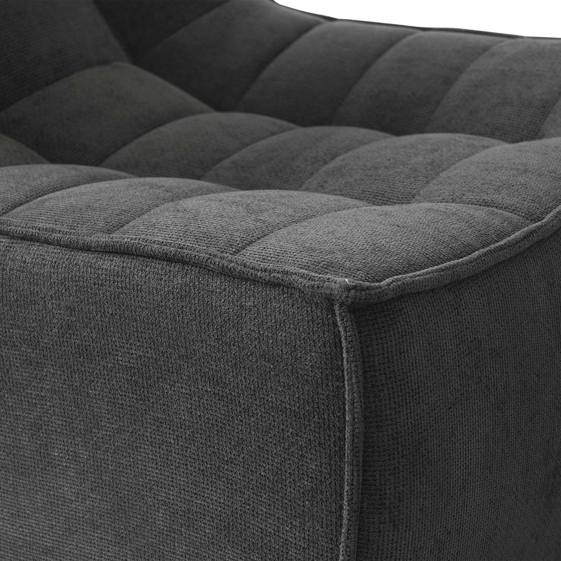 Close-up of a corner of a black waffle floor armchair
