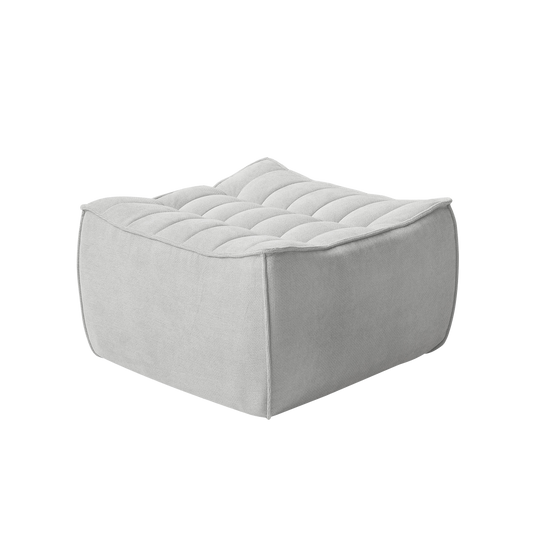 Light gray ottoman with tufted design on a white background
