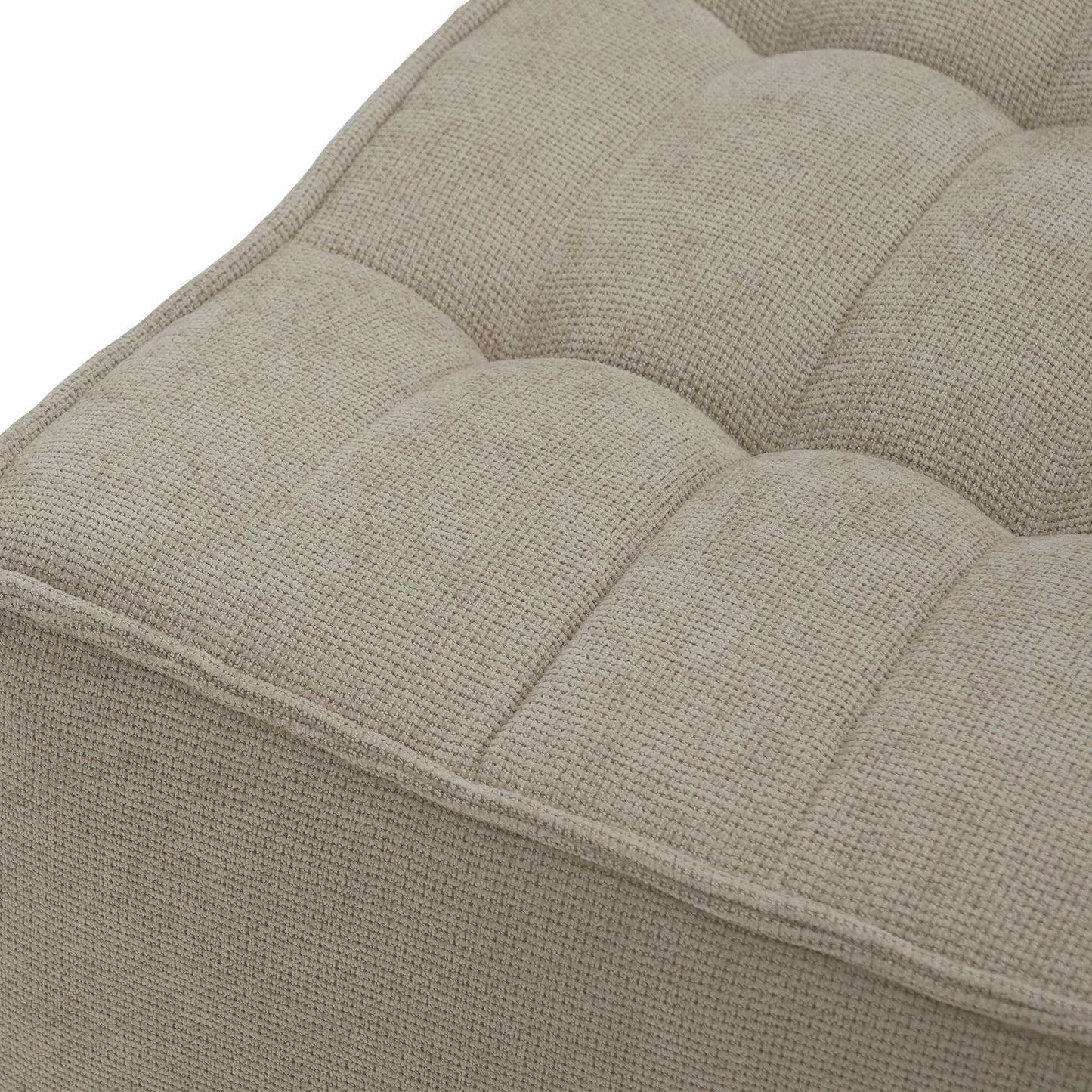 Close-up of a fabric of the seat of a khaki waffle floor sofa