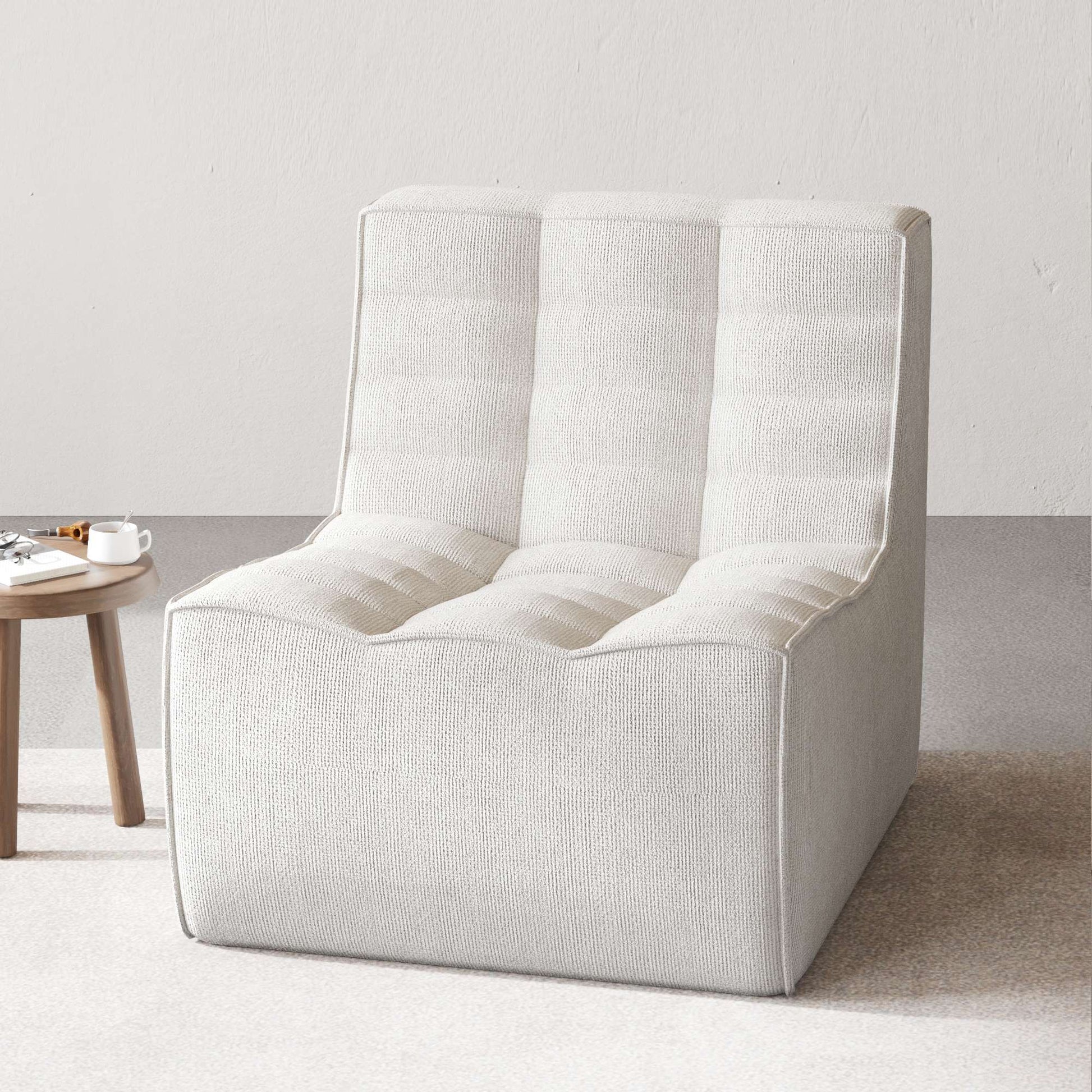 A light gray chenille accent chair with a minimalist design in a day light