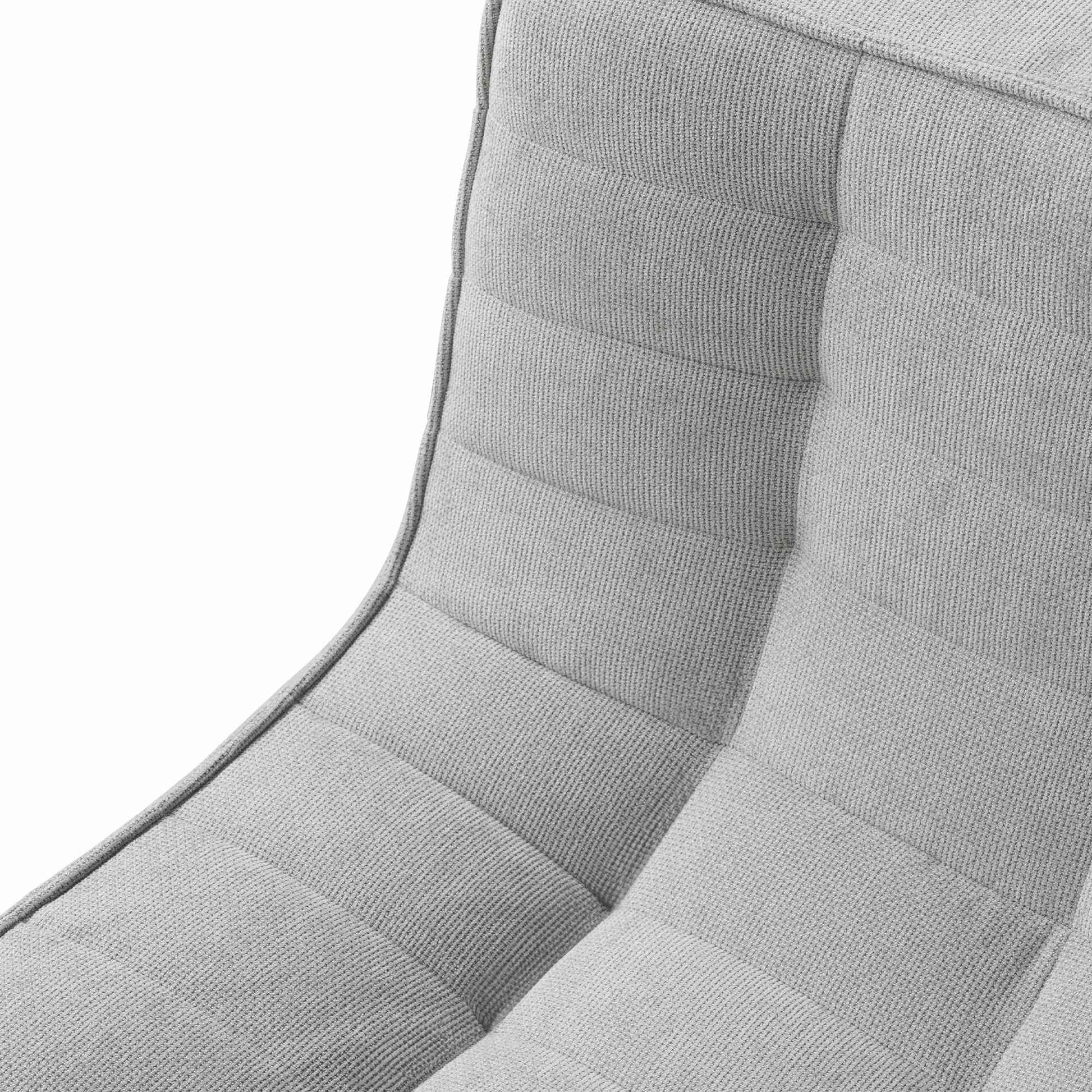 Close-up of a fabric of a gray tufted waffle sofa