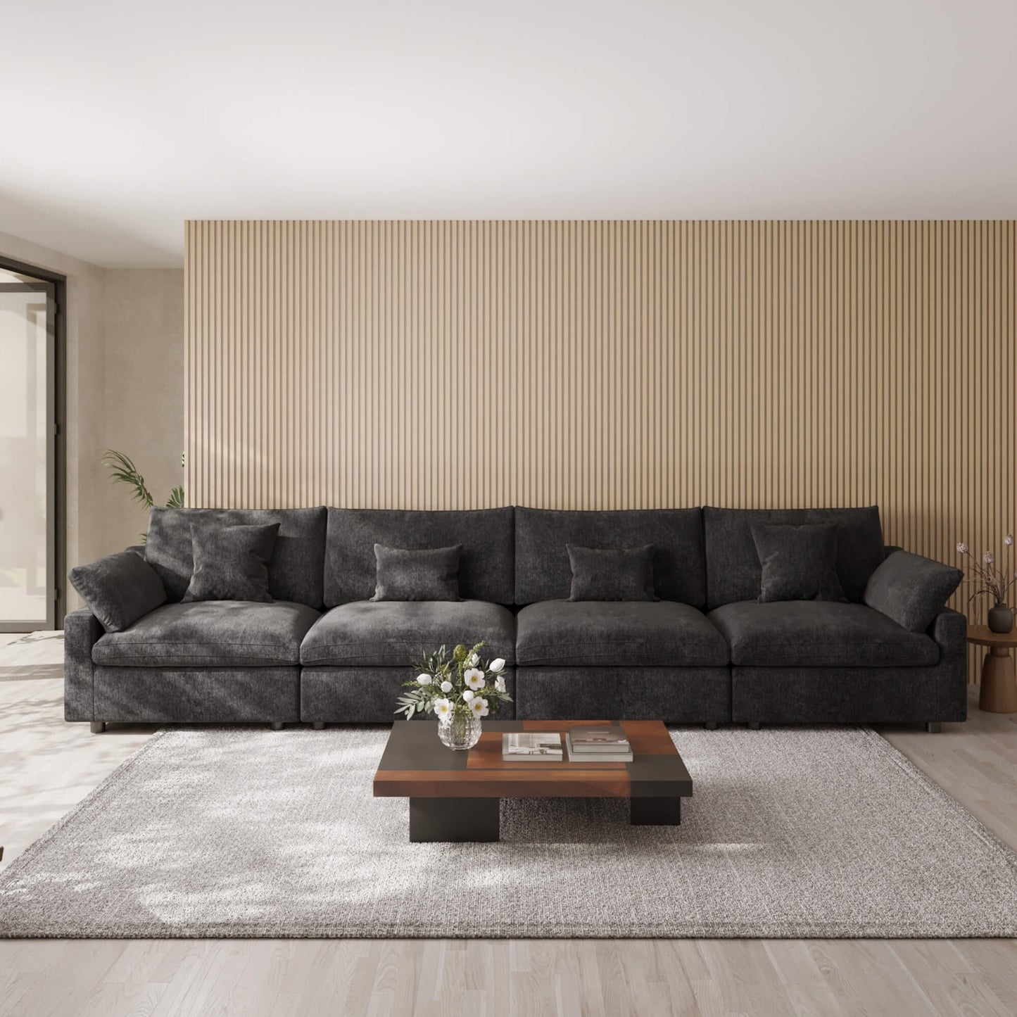 Black 4-seat sectional sofa in a modern living room with a coffee table and decorative items.