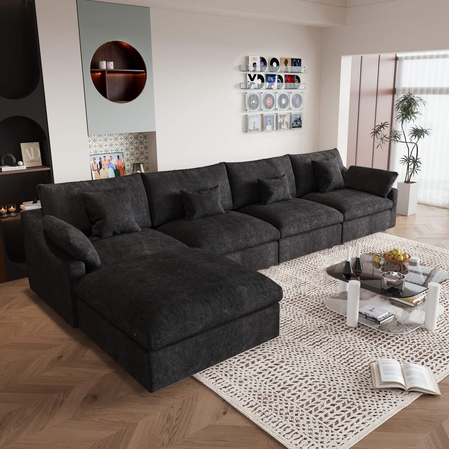 A large, black washable cloud sectional 5-seat sofa with removable cushions and an ottoman, placed in a living room setting.