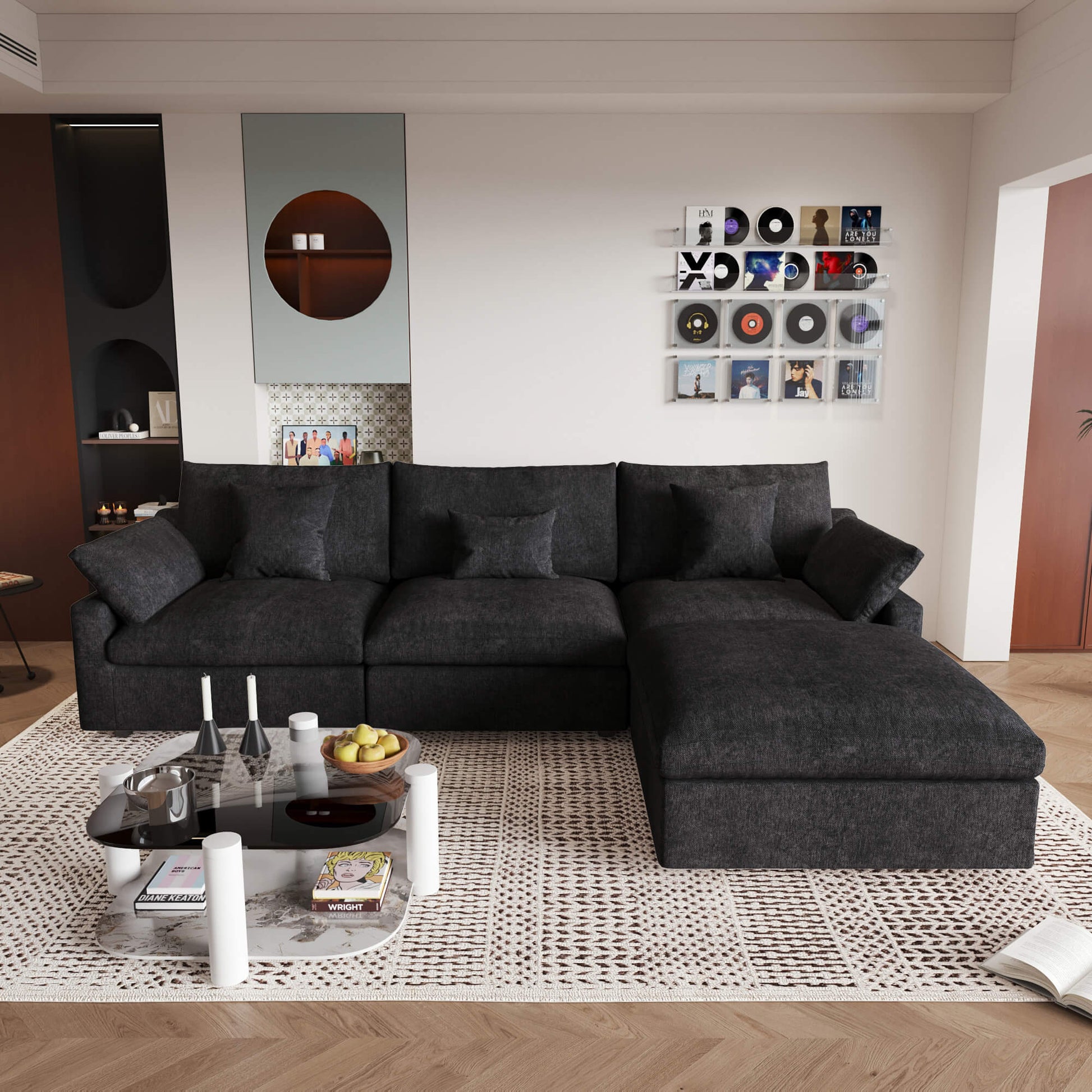 An L-shaped black sectional sofa with removable cushions and pillow covers, placed in a living room setting.