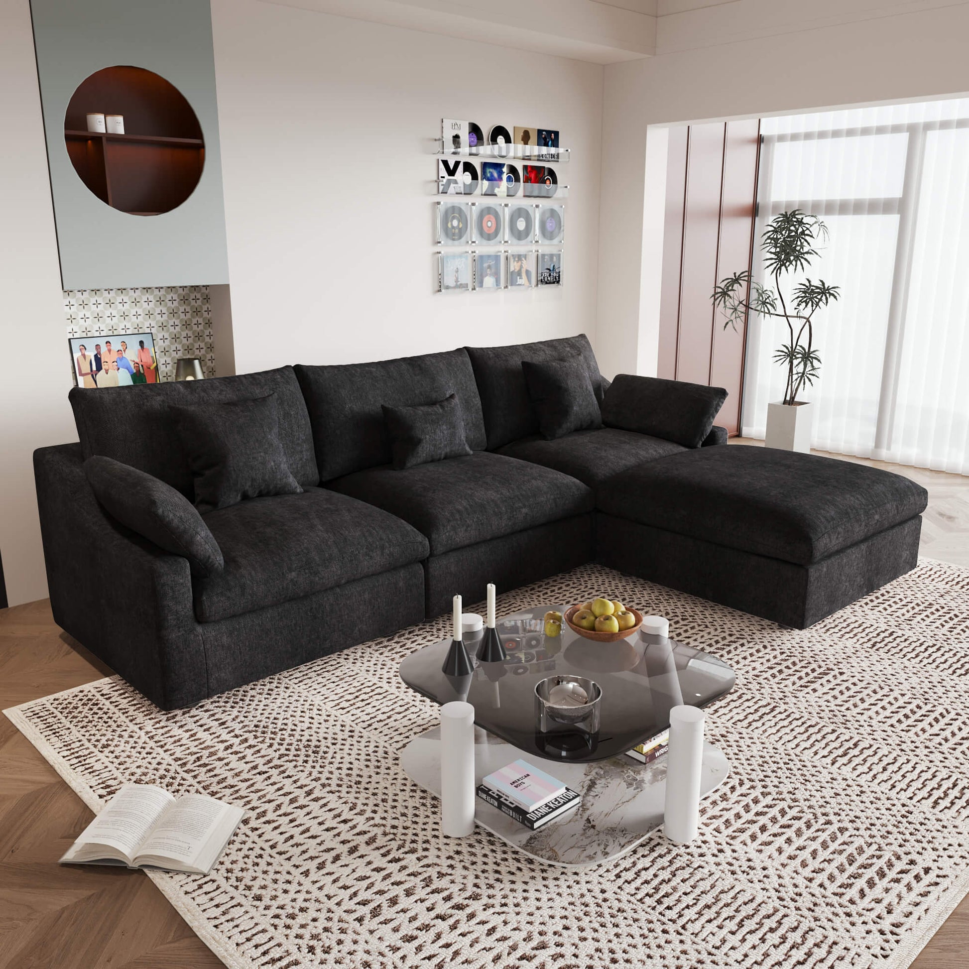 An L-shaped black sectional sofa with removable cushions and pillow covers, placed in a living room setting.