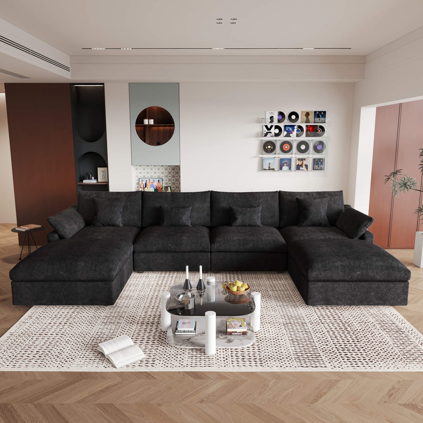 A large black U-shaped sectional sofa with removable cushions and pillow covers, placed in a modern living room setting.