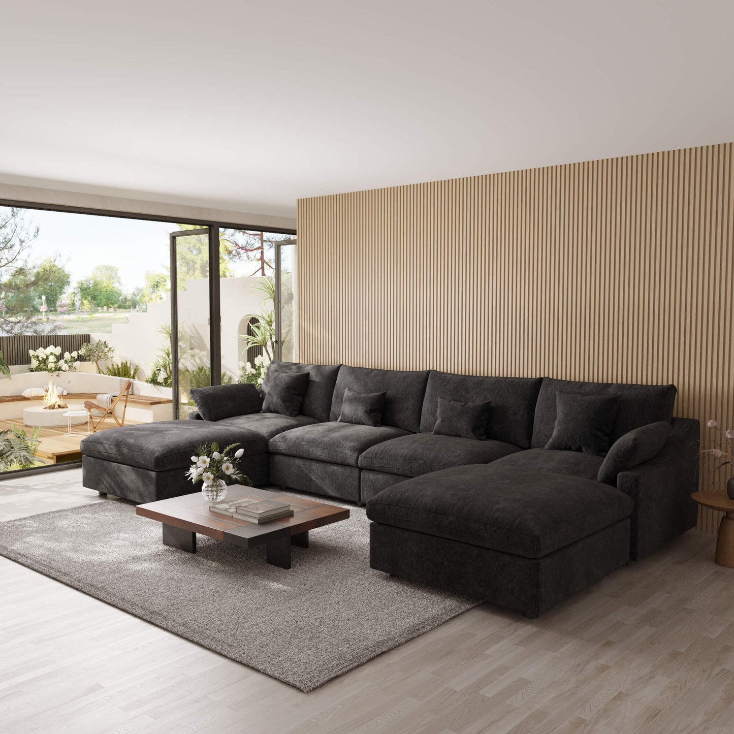 Modern living room with a black U-shaped sectional sofa, coffee table, and decorative elements.