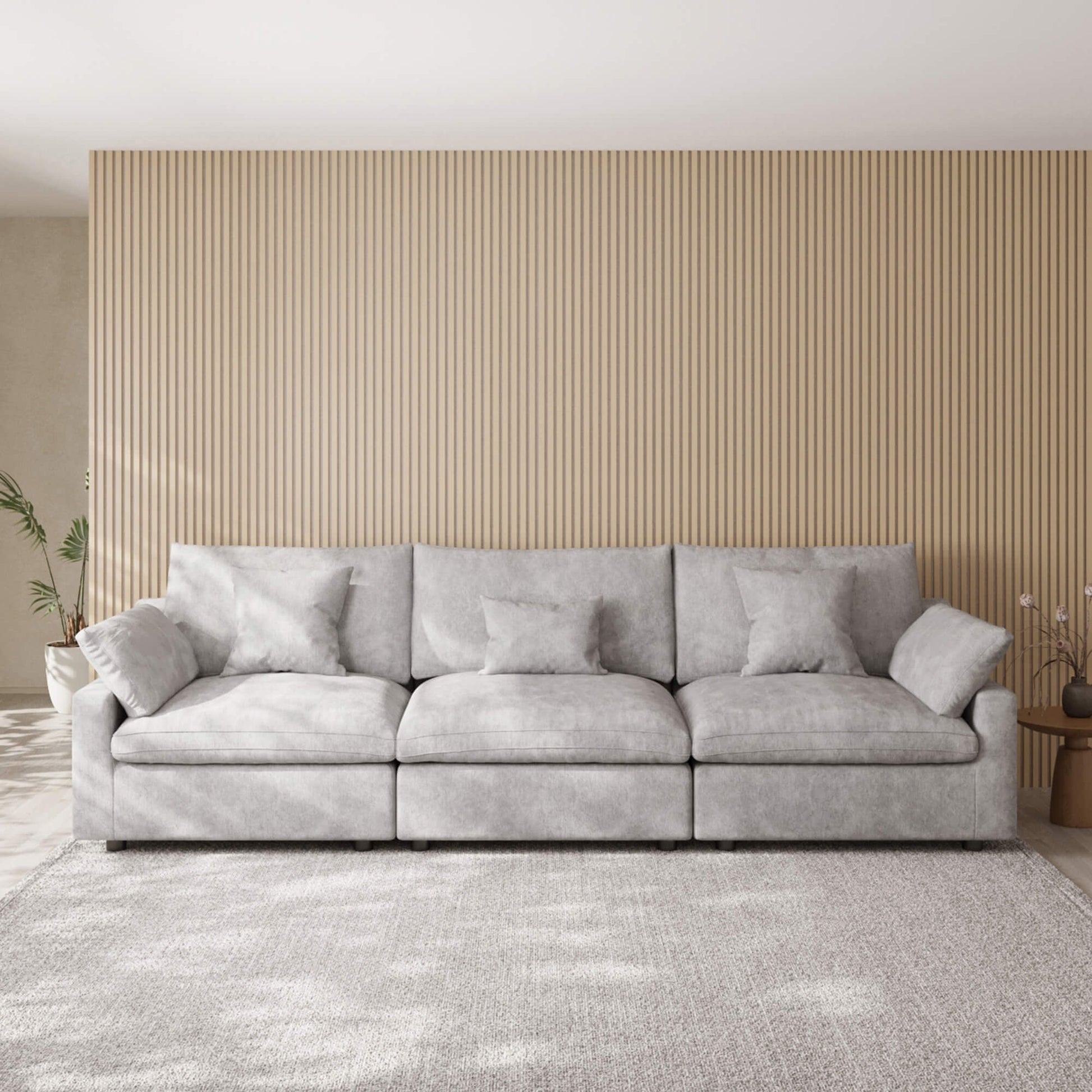 Light gray 3-seater sofa in a room with a striped wall and rug
