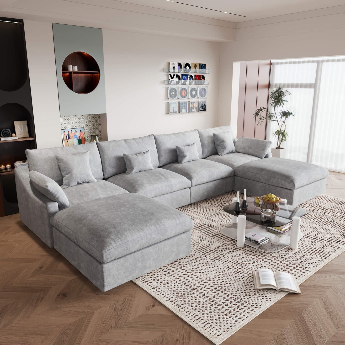 A large light gray U-shaped sectional sofa with removable cushions and pillow covers, placed in a modern living room setting.