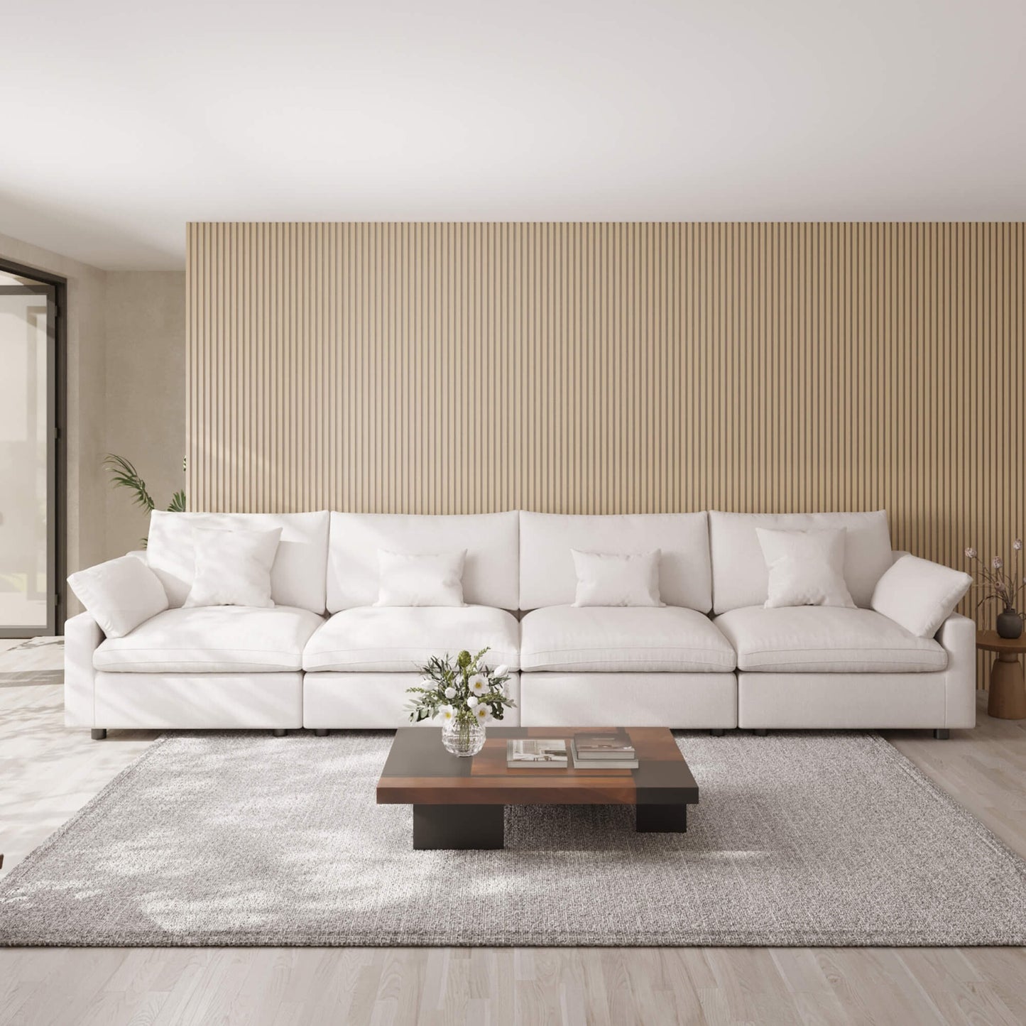 White 4-seat sofa in a modern living room with a wooden coffee table and decorative elements.