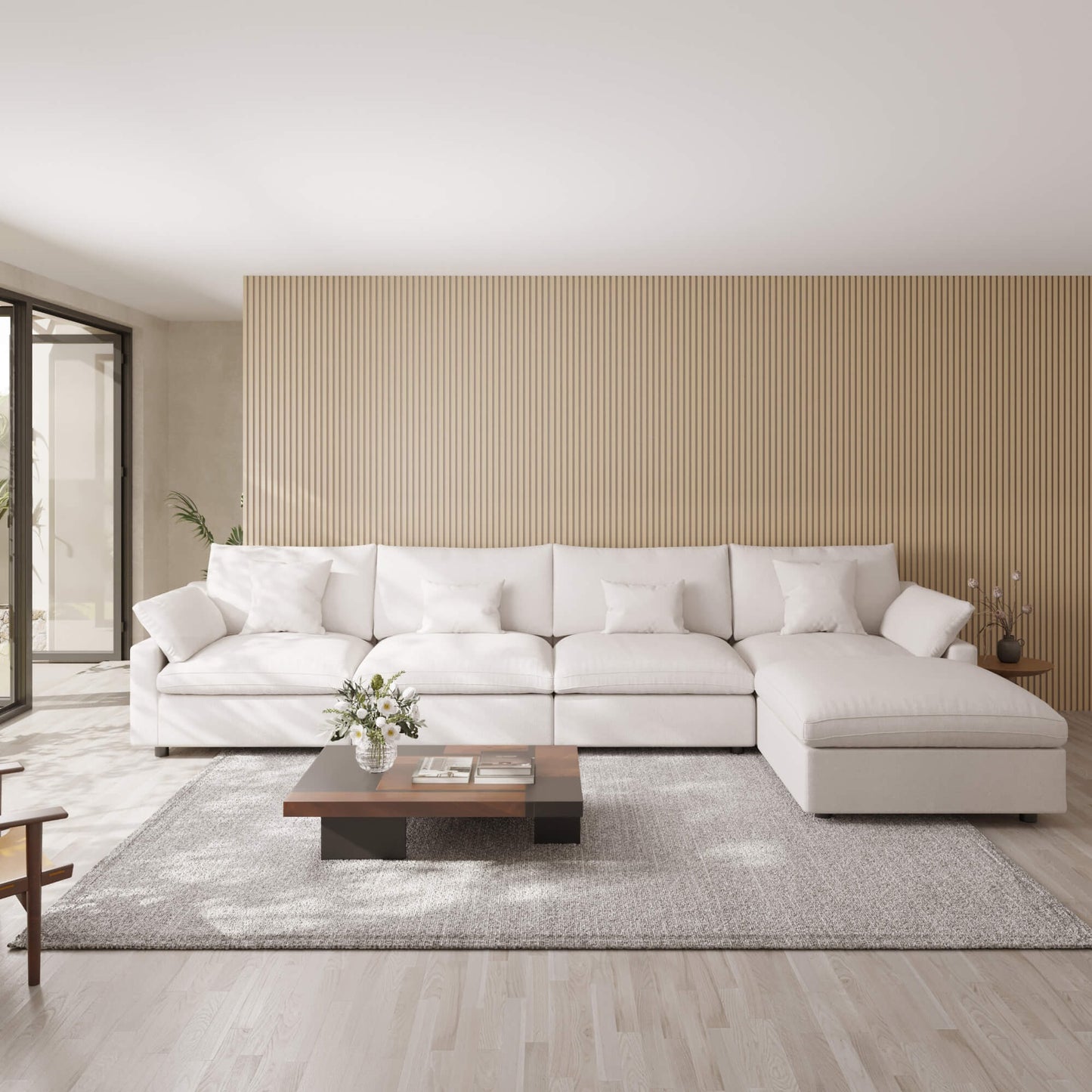 Modern living room with a white 5-seat sectional sofa with ottoman, wooden coffee table, and striped wall.