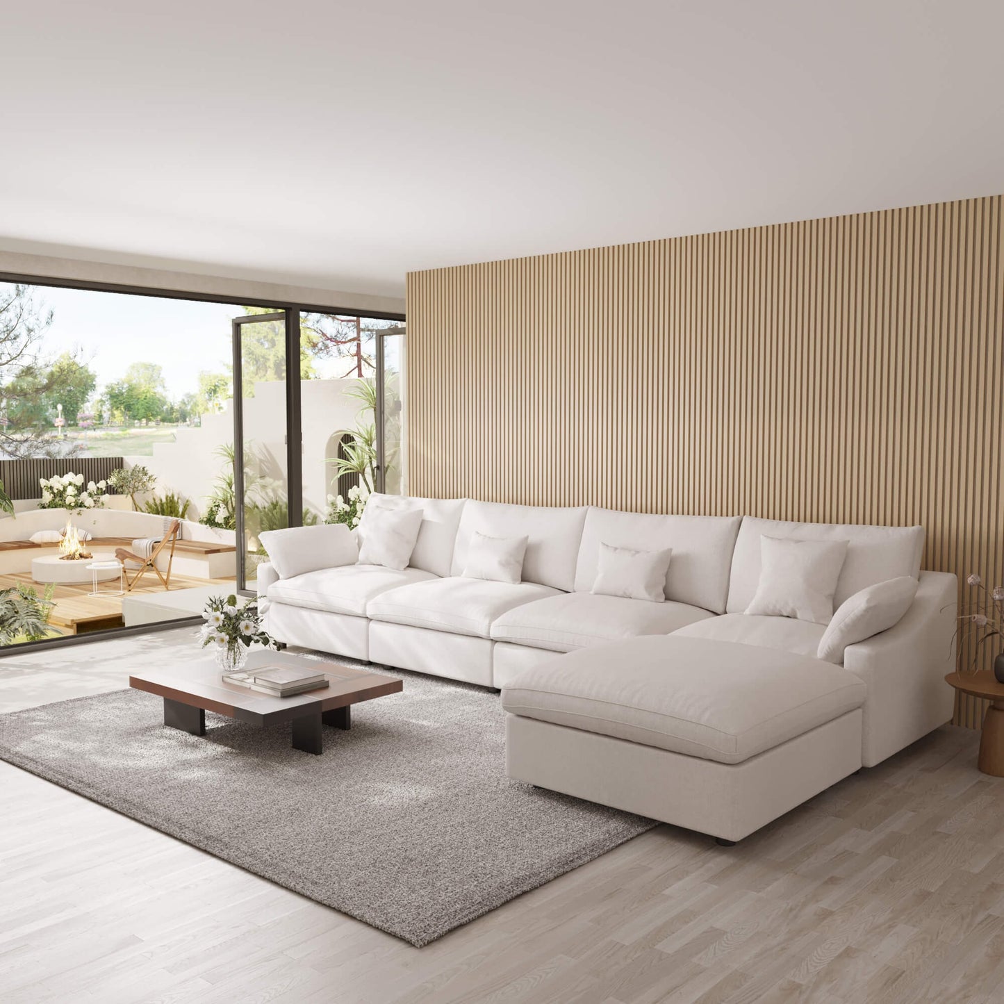 Modern living room with a large white 5-seat sectional sofa with ottoman, coffee table, and decorative elements.