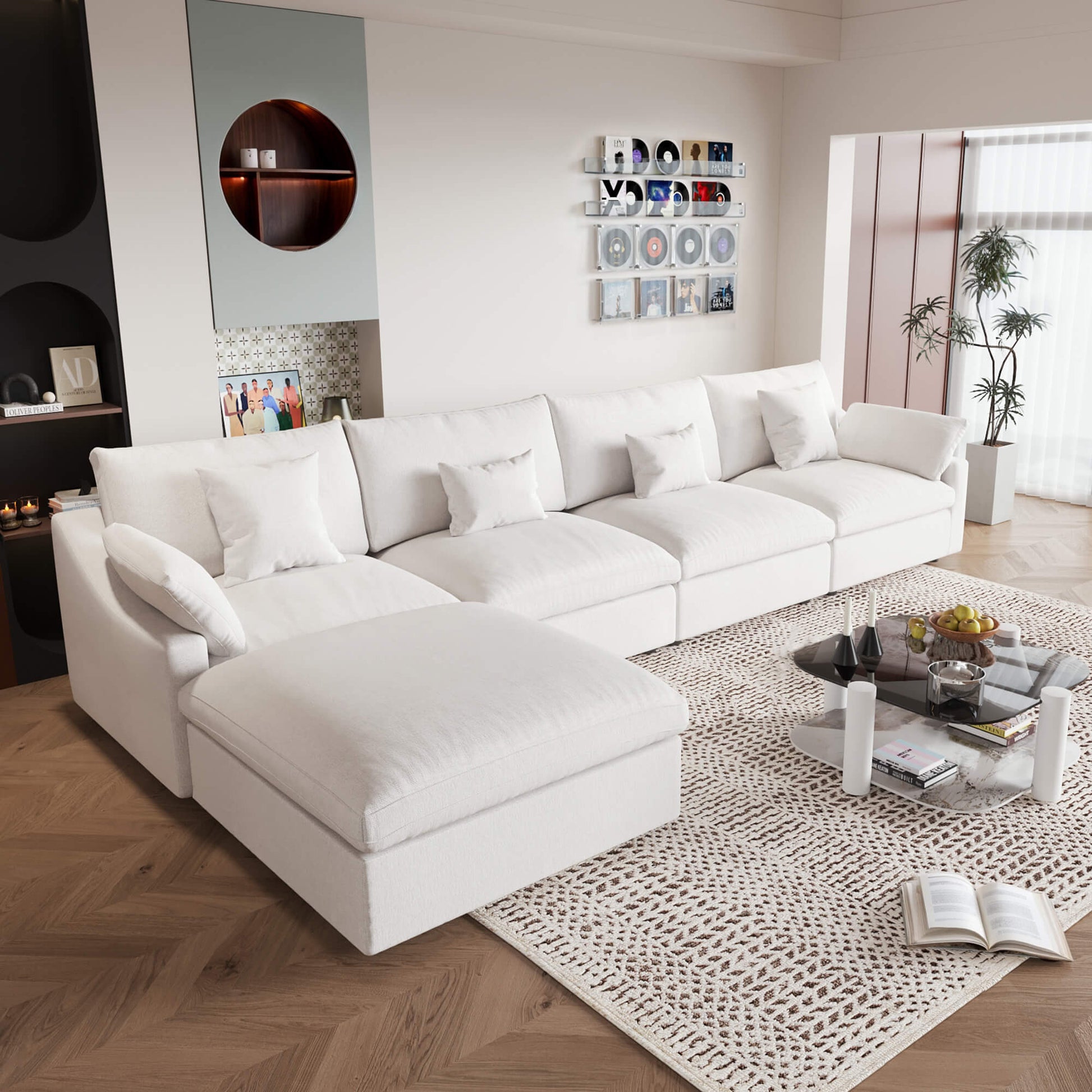 A large, white washable cloud sectional 5-seat sofa with removable cushions and an ottoman, placed in a living room setting.