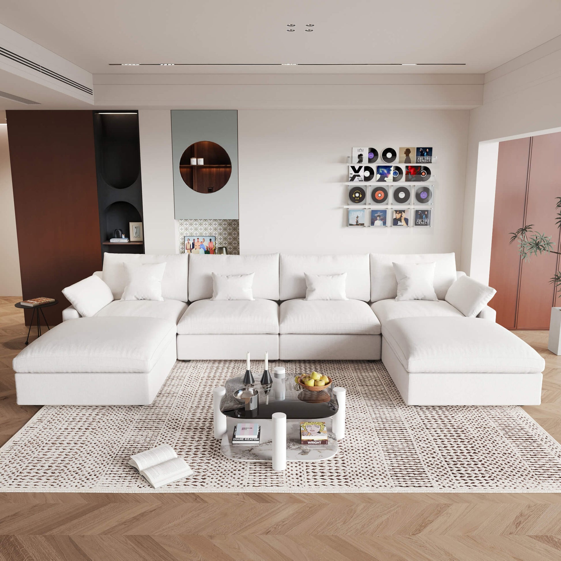 A large white U-shaped sectional sofa with removable cushions and pillow covers, placed in a modern living room setting.