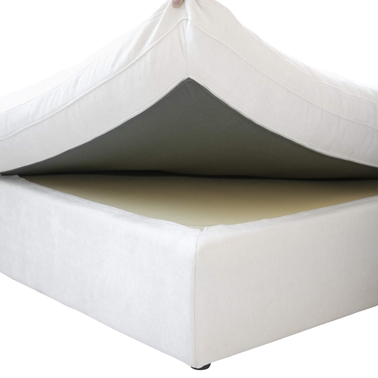 Close-up of a seat cushion being held up to show a frame of a white couch