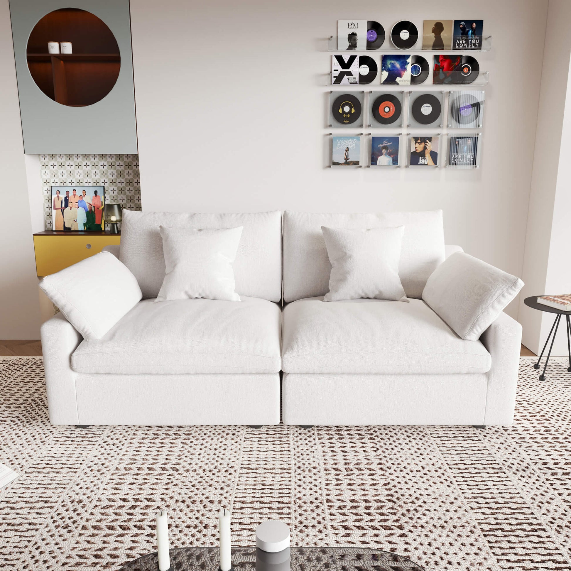 A white loveseat sofa, featuring a minimalist design with removable cushions, placed in a room with modern decor.
