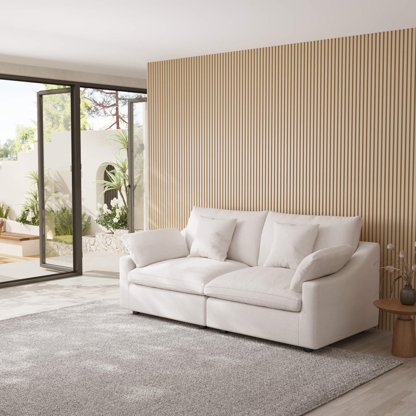 White loveseat sofa in a modern living room with a striped wall and patio doors.