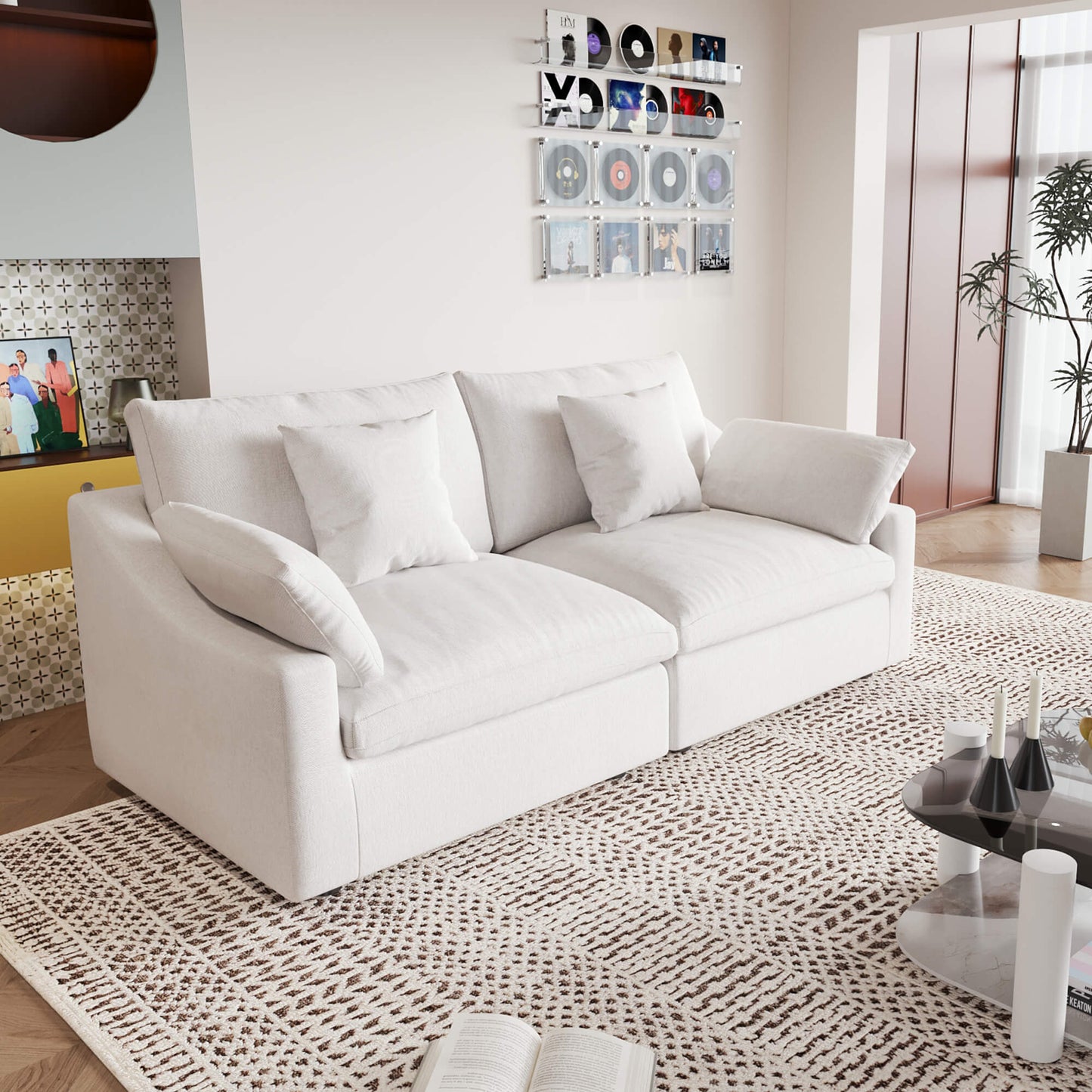 A white loveseat sofa, featuring a minimalist design with removable cushions, placed in a room with modern decor.