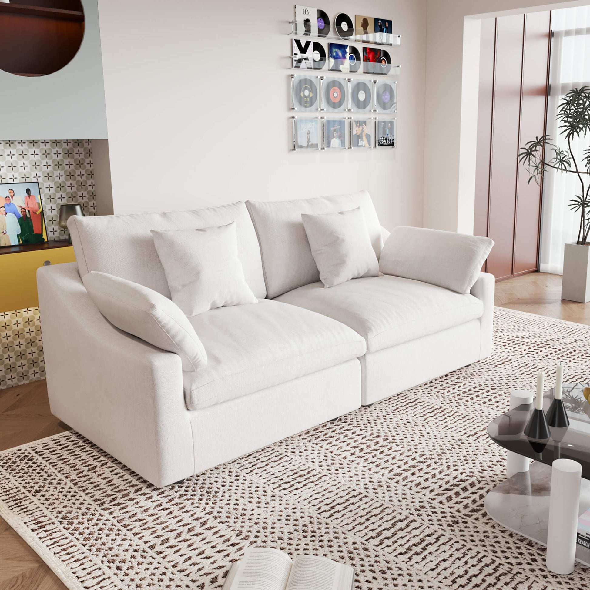 A white loveseat sofa, featuring a minimalist design with removable cushions, placed in a room with modern decor.