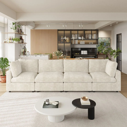 Modern living room with a beige 4-seater sofa, coffee table, and decorative items.