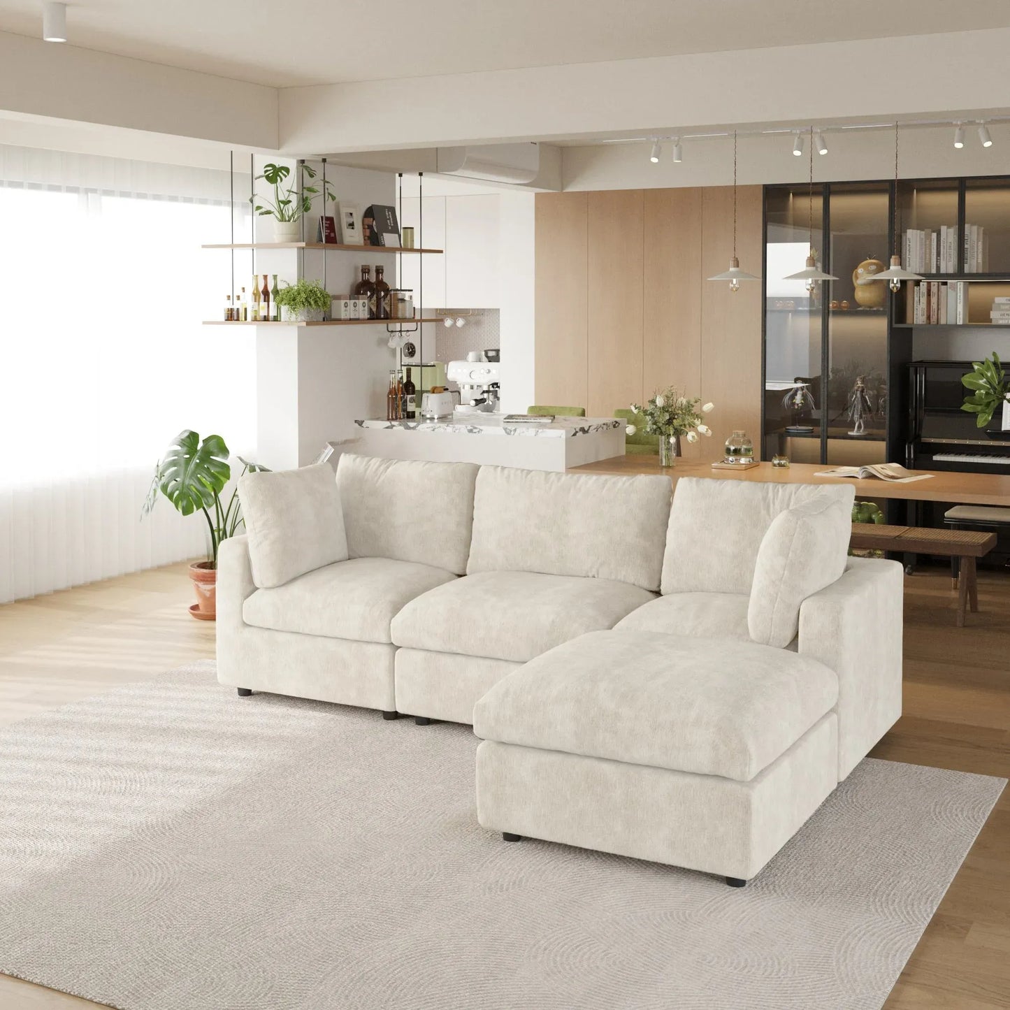 Beige L-shaped 4-seater sectional sofa in a modern living room with a kitchen in the background.