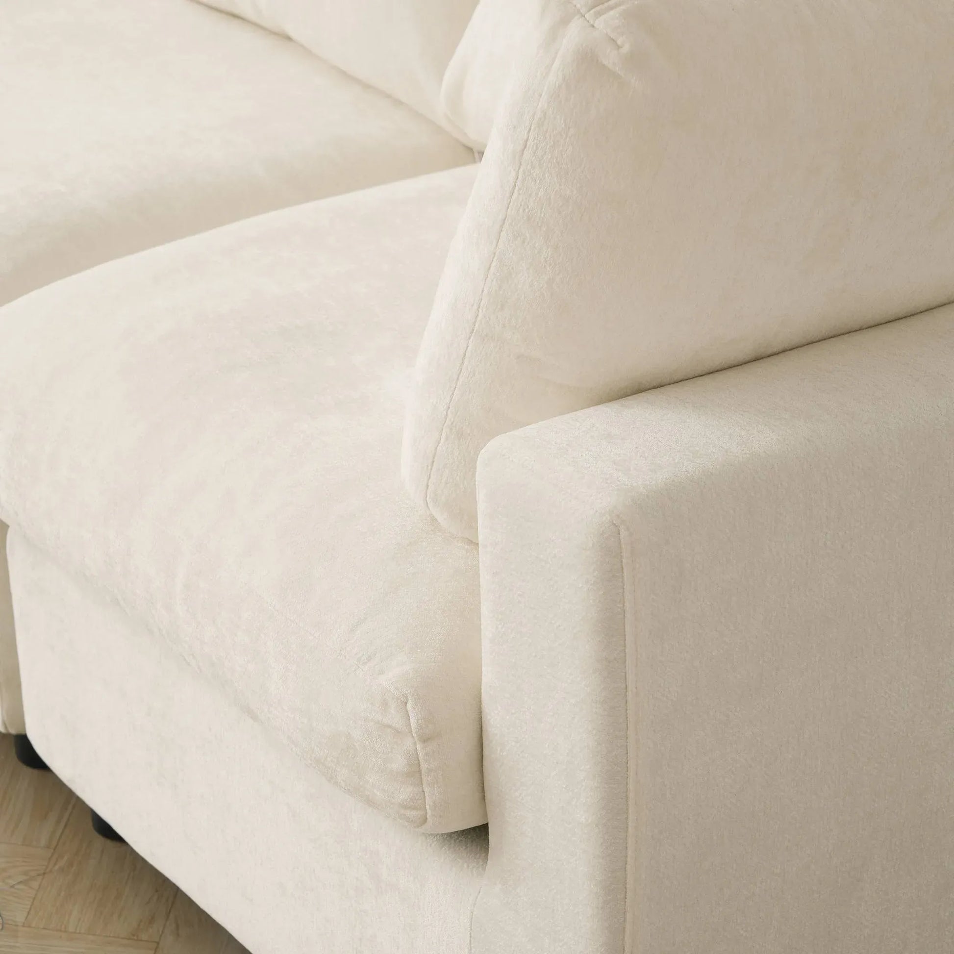 Close-up of a beige sofa with a textured fabric surface.